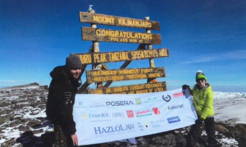 Posera at the top of Kilimanjaro mountain blog post